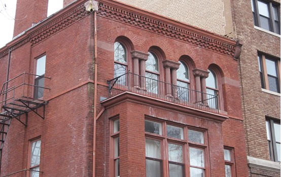 Restoration of historic masonry and tuckpointing on a classic brick building.