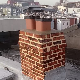 Historic brick chimney with detailed masonry work and tuckpointing.