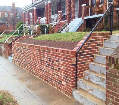 Restoration of historic brick masonry and tuckpointing on a residential building.