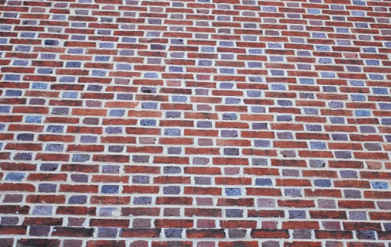 Brick masonry wall with detailed tuckpointing and historic craftsmanship.
