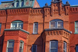 Historic brick building in Washington, DC featuring decorative masonry, bay windows, and preserved architectural details.