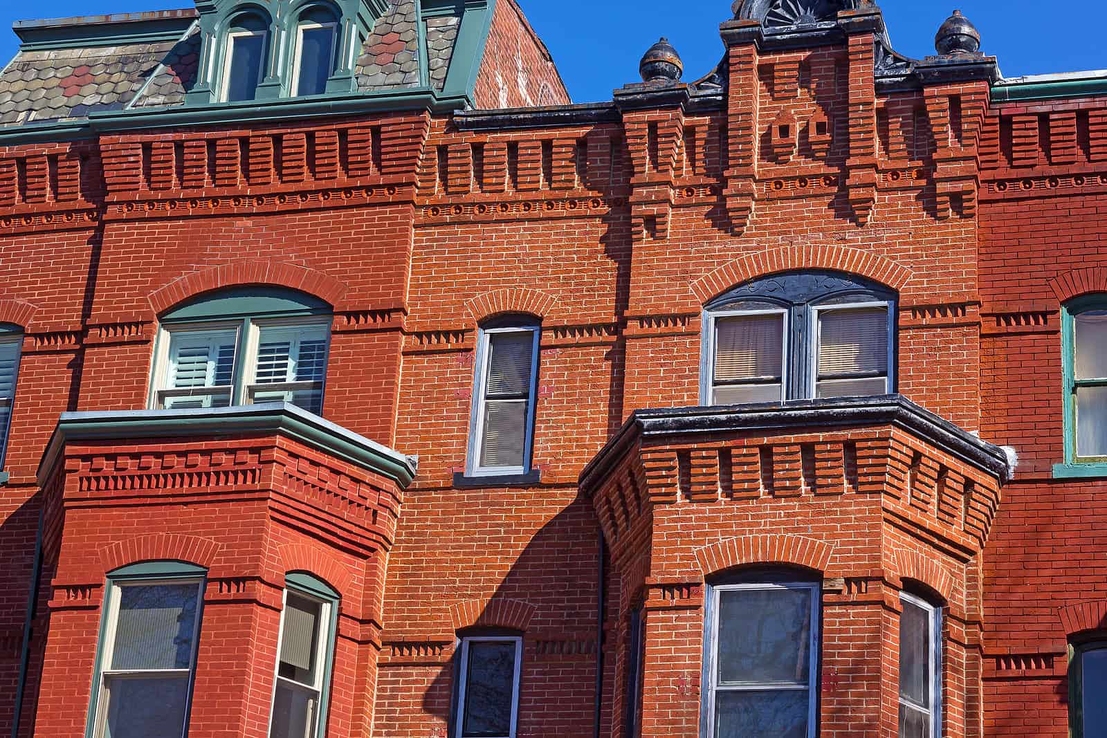Historic brick masonry and tuckpointing on a Renaissance-style building facade.