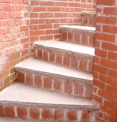 Restoration of historic brick stairs with detailed masonry and tuckpointing work.