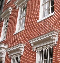 Restoration of historic brick masonry and tuckpointing on a Renaissance-style building.