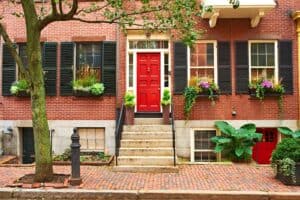 Restoration of historic brick masonry with precise tuckpointing and masonry work on a classic red brick rowhouse.
