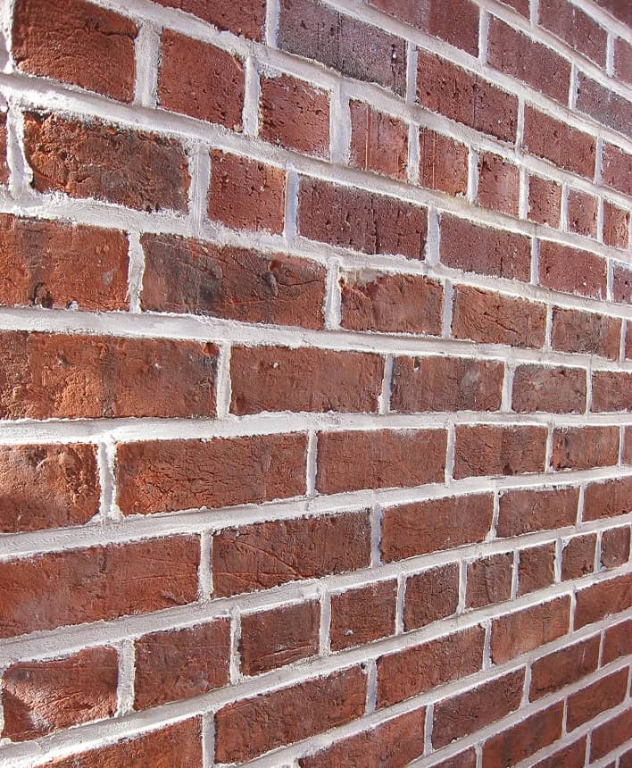 Brick wall with historic masonry and tuckpointing details.