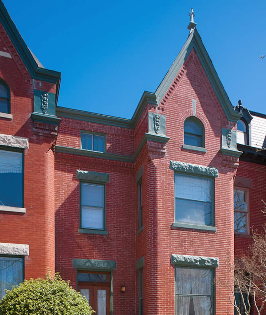 Historic brick building with detailed masonry work and decorative elements.