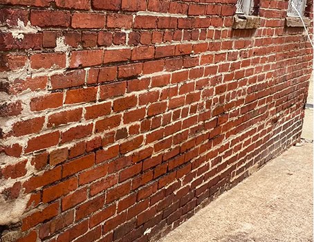 Close-up of historic brick wall with masonry and tuckpointing work.