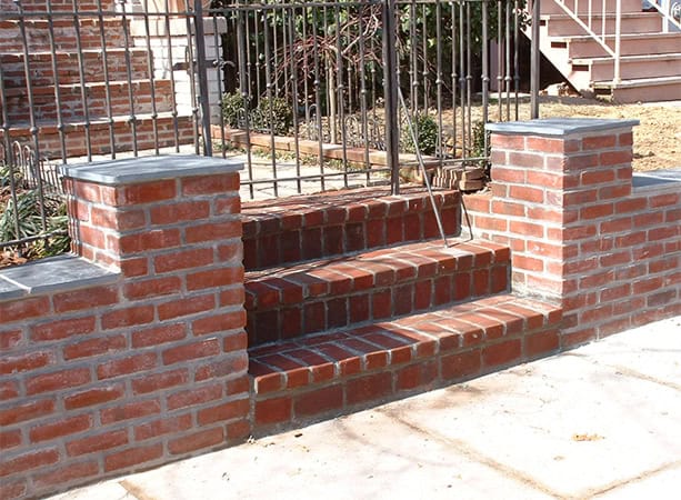 Brick staircase with wrought iron railing and brick wall base, part of Renaissance Development proje.