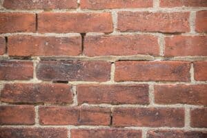 Historic brick masonry wall with tuckpointing and weathered mortar.