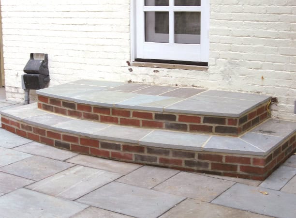 Beautifully restored brick and stone steps with detailed masonry work.