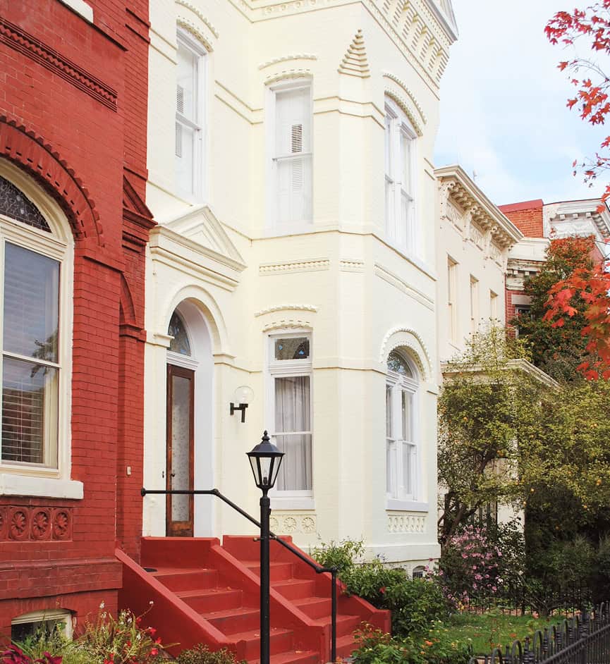 Historic masonry and tuckpointing on a Victorian-style building in a city neighborhood.
