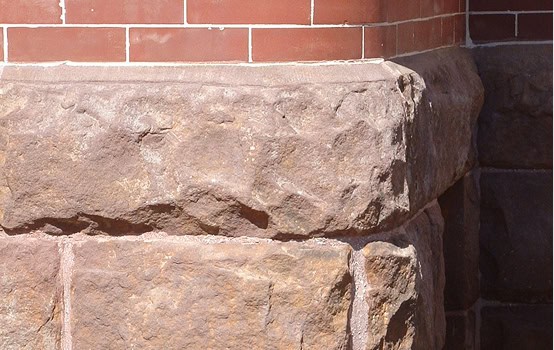 Close-up of historic masonry and tuckpointing on a brick building.