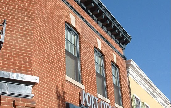 Historic brick building with masonry and tuckpointing work in progress.