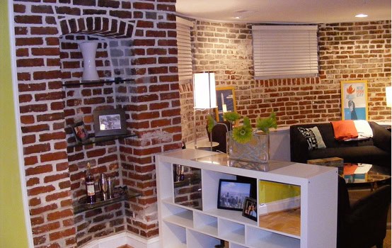Interior of a renovated brick wall with modern decor and furniture.