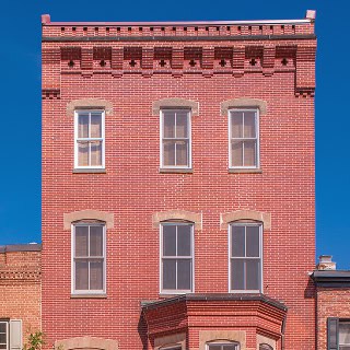 Historic brick building with detailed masonry and tuckpointing work.