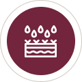 icon stable Stylized cake icon with droplets in maroon circle