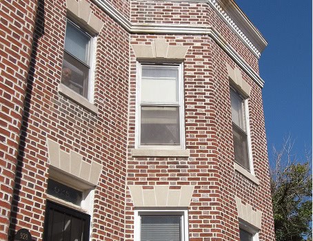 Close-up of brick masonry and tuckpointing on historic building exterior.