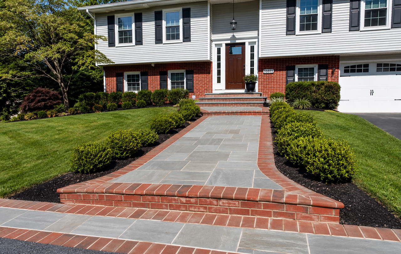 Brick walkway leading to suburban home entrance