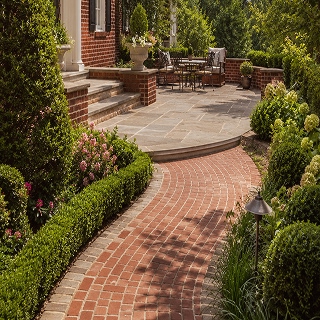 proven-experience Curved brick walkway leading to backyard patio