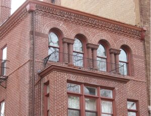 Historic brick building in Washington, DC featuring decorative masonry, arched windows, and well-maintained mortar joints.