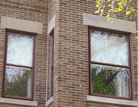 Close-up of brick masonry and window frames showing tuckpointing work.