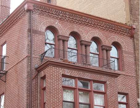 Historic brick building in Washington, DC featuring decorative masonry, arched windows, and well-maintained mortar joints.